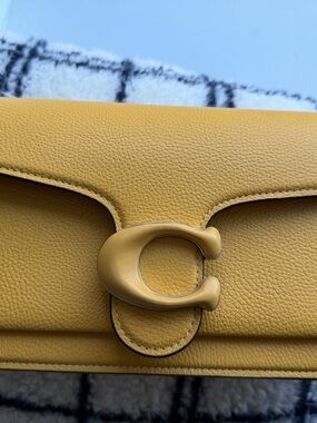 Coach Yellow Tabby Pebbled Leather Crossbody with Signature C Clasp.